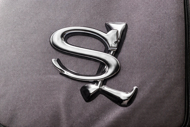 Sailuc metallic logo on textured gray luxury fabric