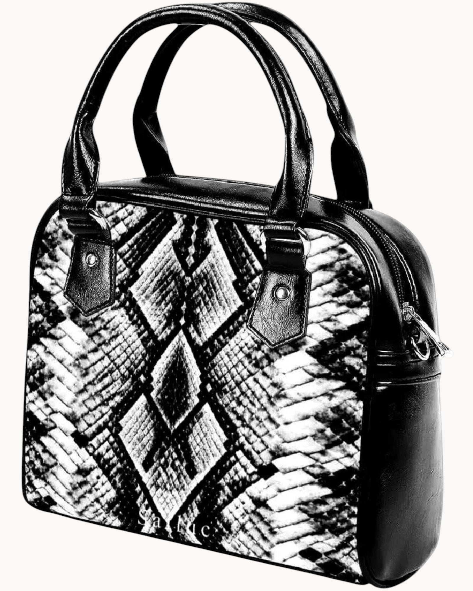 Black and white patterned handbag with black handles on a gray background
