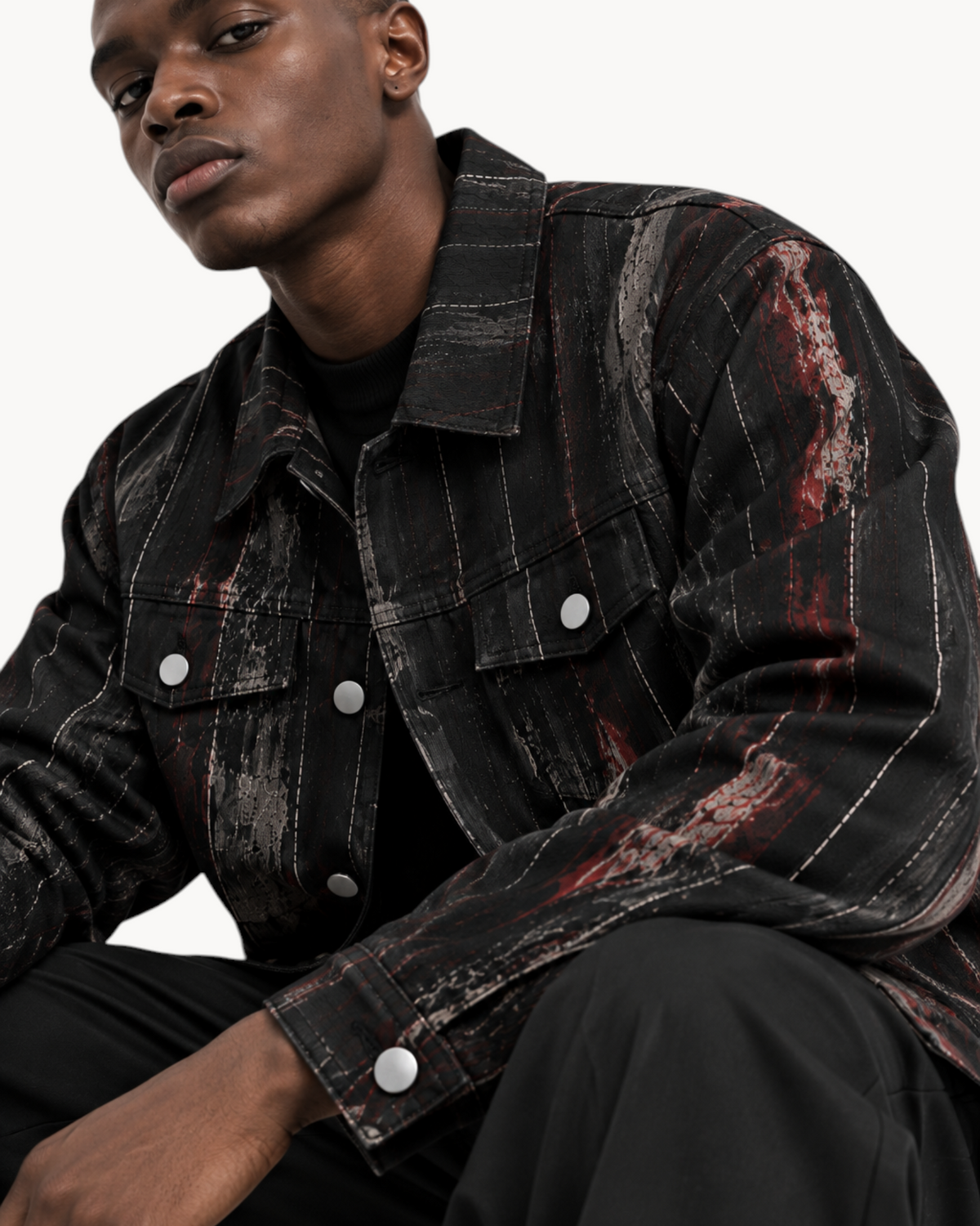 Sailuc Strata collared jacket in textured black fabric with decorative pockets worn by a male model.