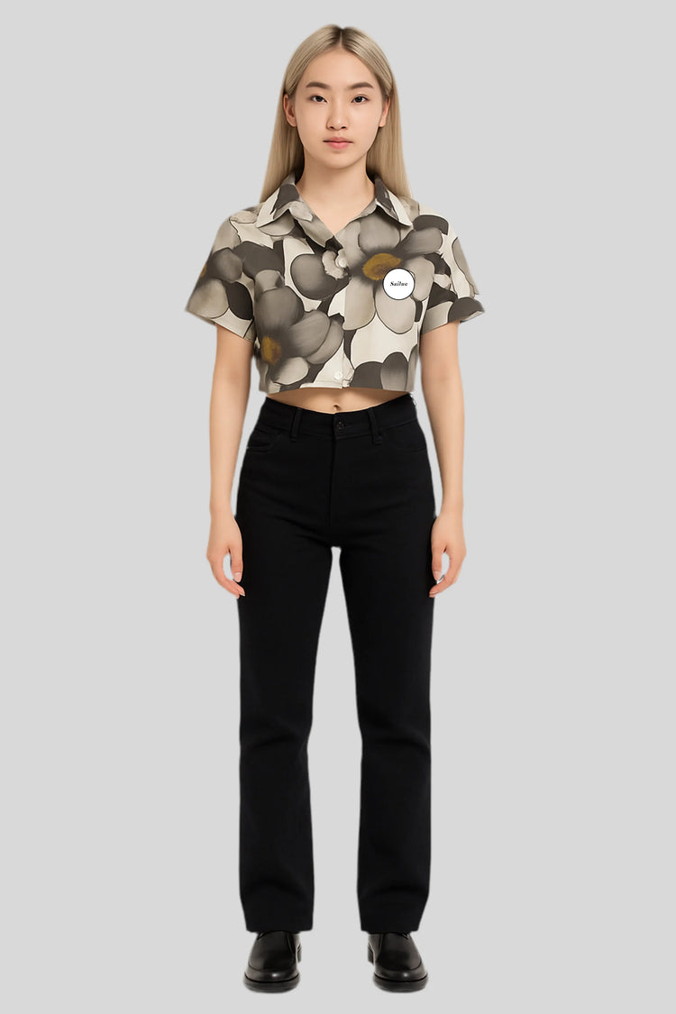 Woman in Sailuc floral cropped shirt and black pants, showcasing luxury modern fashion.