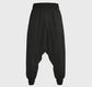 Black harem pants on a gray background