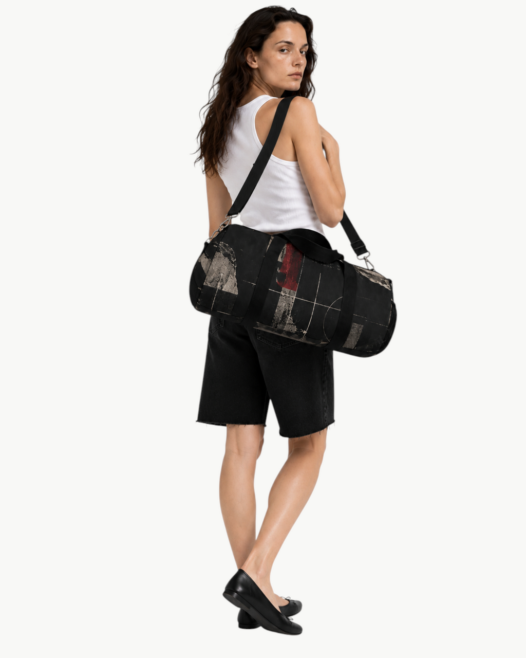 Sailuc Obscura duffle bag in black Oxford canvas with abstract art, worn over the shoulder by a woman in white tank.