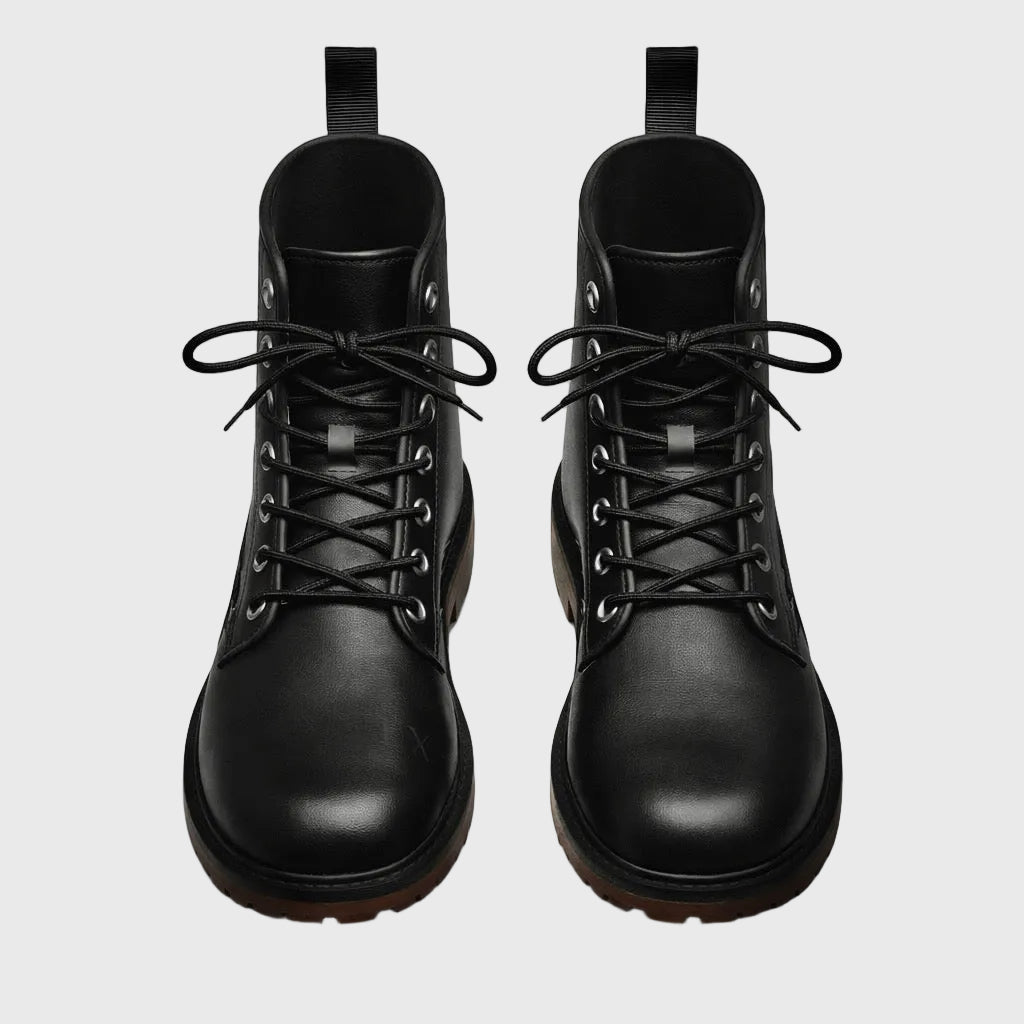 Pair of black leather boots on a gray background