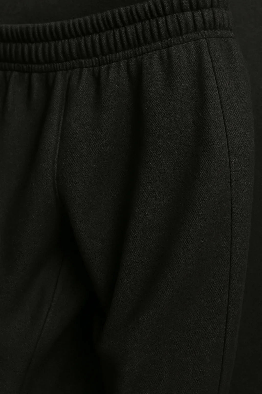 Close-up of black Sailuc luxury fashion jogger pants with elastic waistband