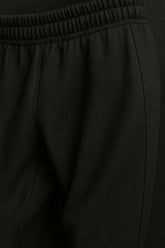 Close-up of black Sailuc luxury fashion jogger pants with elastic waistband