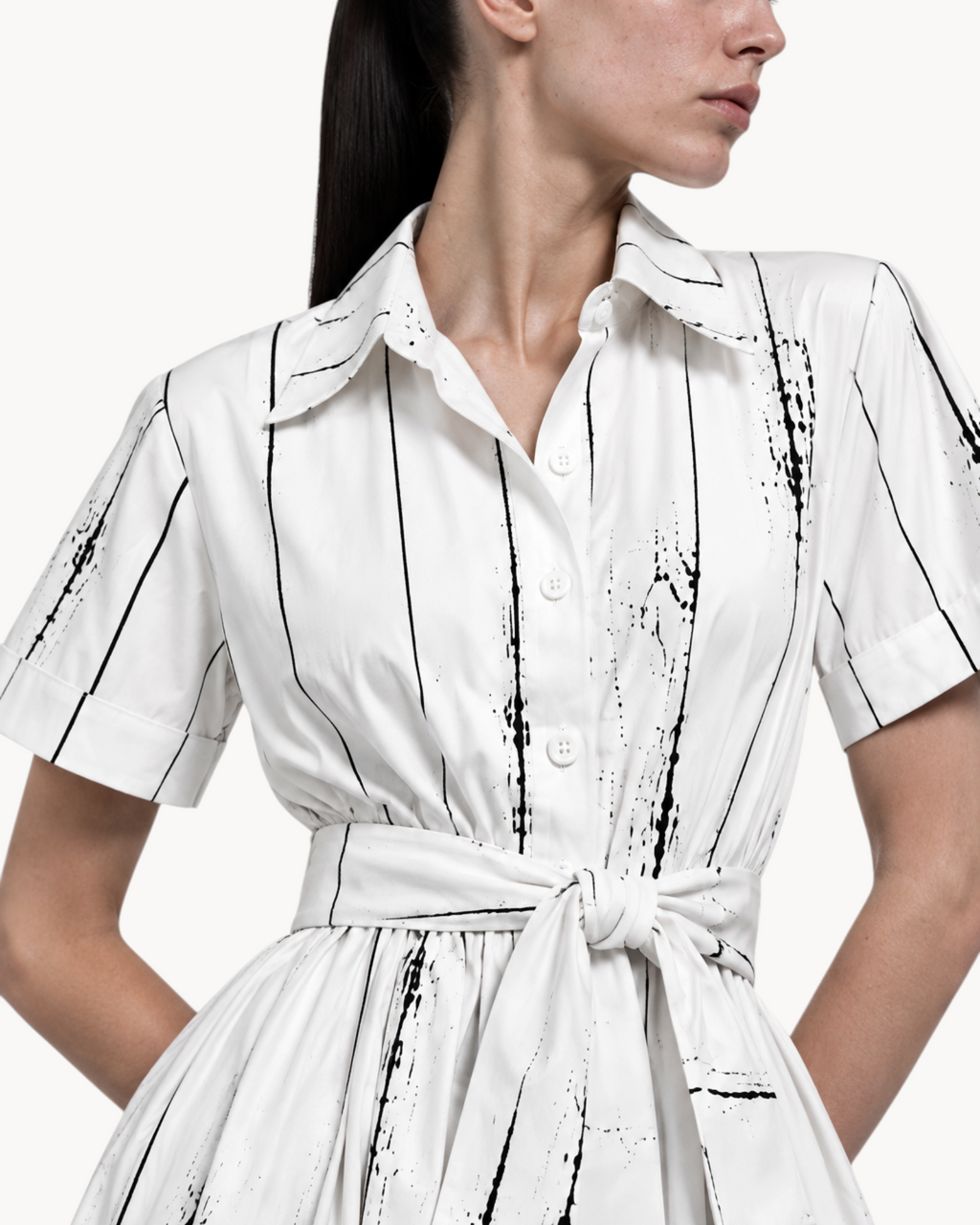 Sailuc Liora shirt dress in white with black vertical brushstroke print, featuring a collar and waist tie.