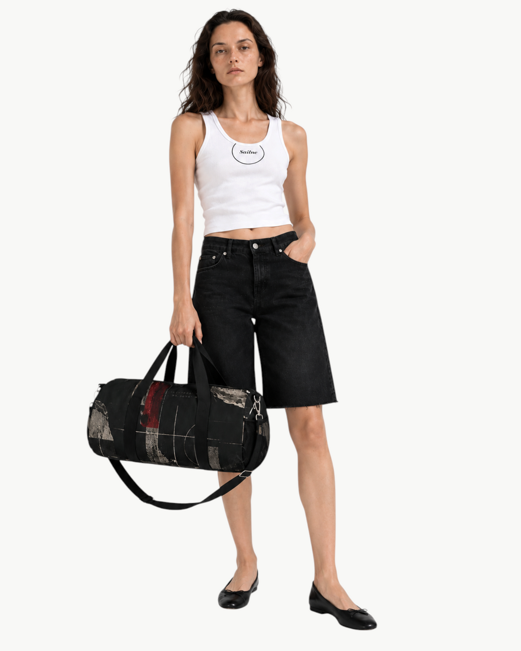 Sailuc Obscura duffle bag with dark abstract art, held by a model wearing a white tank top and black denim shorts.