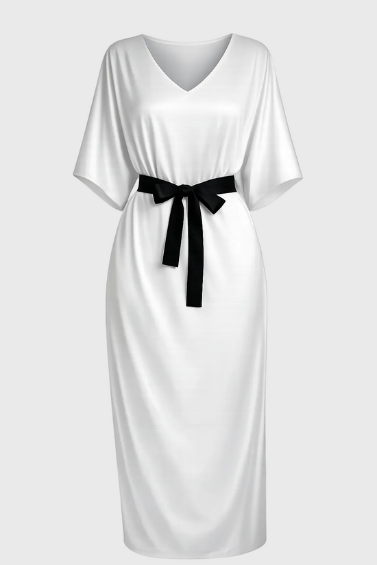 White dress with a black belt on a gray background