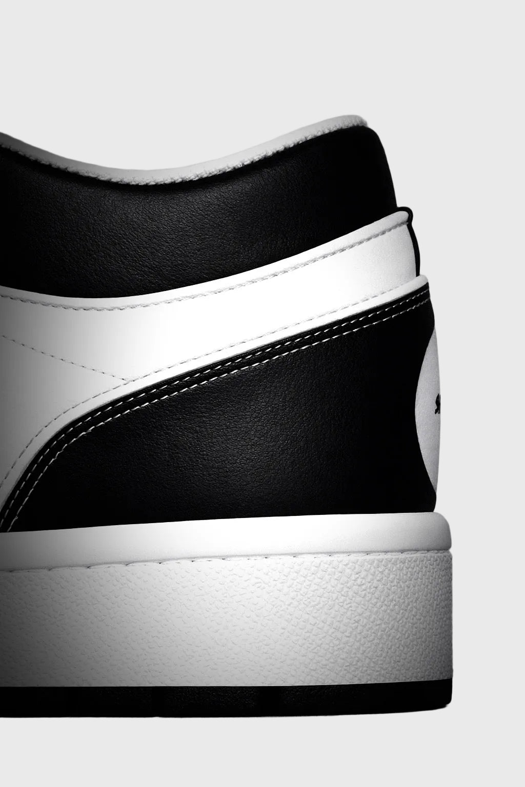 Close-up of a black and white sneaker on a gray background