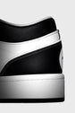 Close-up of a black and white sneaker on a gray background