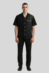 Man modeling Sailuc luxury black short-sleeve shirt and trousers, modern fashion style