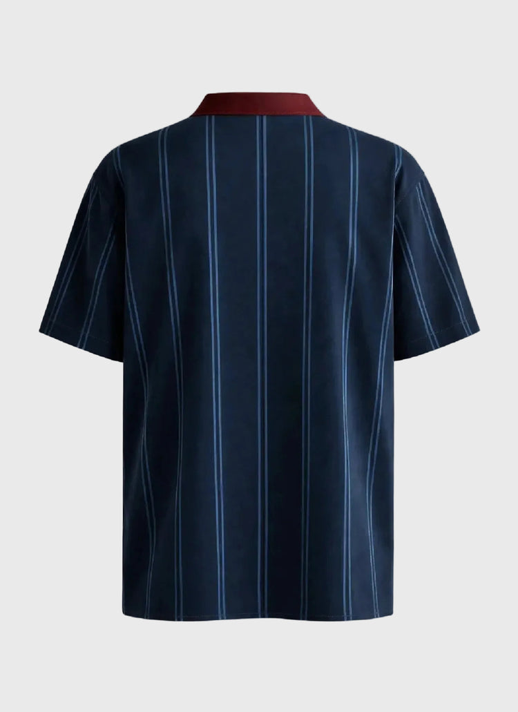 Navy pinstripe shirt on a gray background