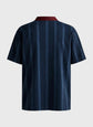 Navy pinstripe shirt on a gray background