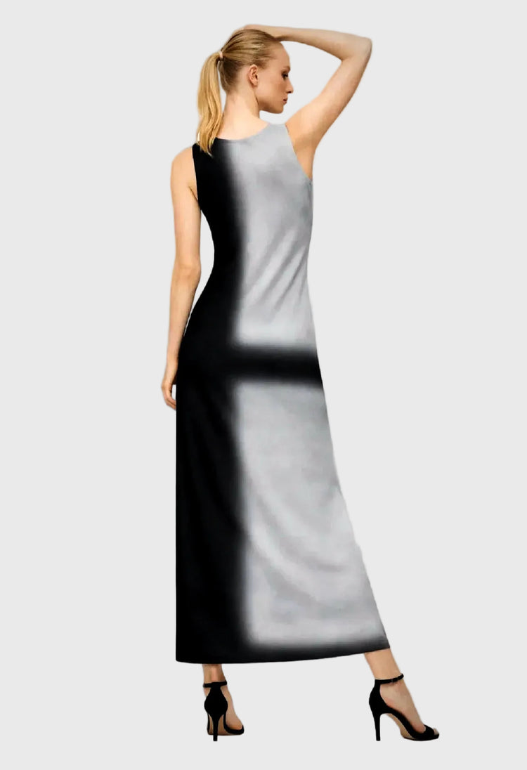 Woman wearing a black and gray dress on a gray background