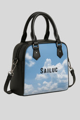Sailuc luxury handbag with cloud print and black leather handles on a gray background