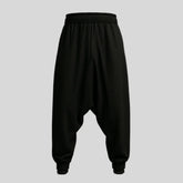 Sailuc black drop-crotch jogger pants with elastic waistband and cuffed hems on gray background