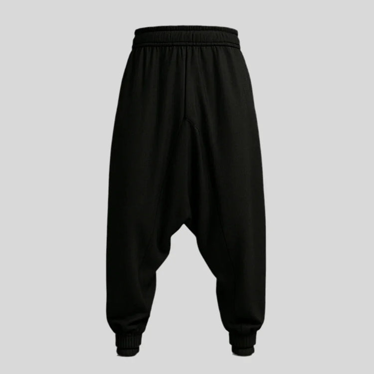 Sailuc black drop-crotch jogger pants with elastic waistband and cuffed hems on gray background