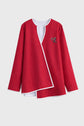 Red top with a white shirt underneath on a light gray background