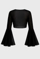 Black blouse with flared sleeves on a gray background