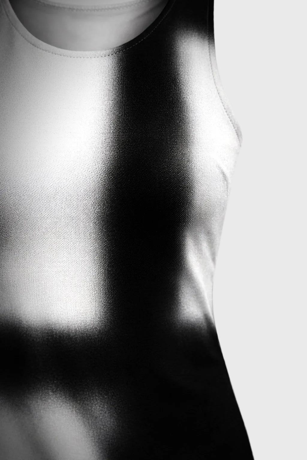 Close-up of a white tank top with a blurred background