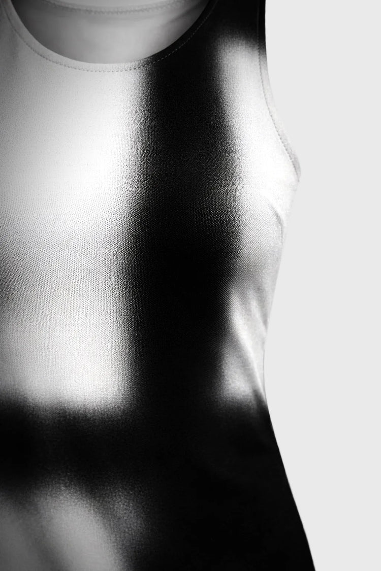 Close-up of a white tank top with a blurred background