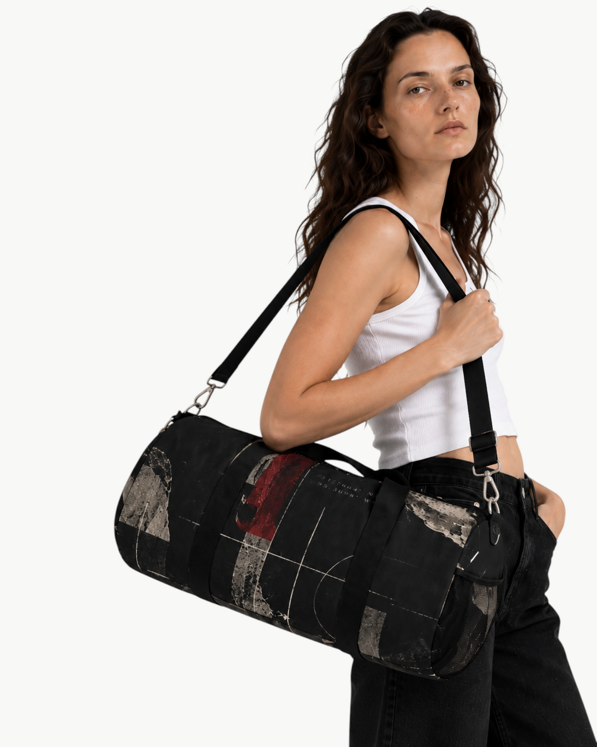 Sailuc Obscura duffle bag in black Oxford canvas with abstract print, worn over the shoulder by a woman.