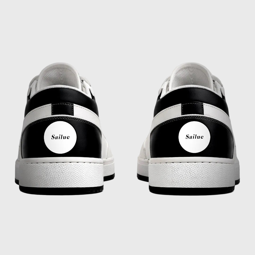 Black and white sneakers with Sailuc branding on a gray background
