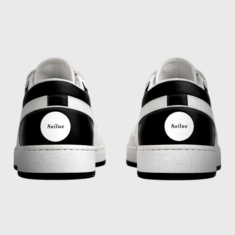 Black and white sneakers with Sailuc branding on a gray background