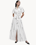 Sailuc Liora shirt dress in white with black vertical abstract stripes, featuring a button front and waist tie.