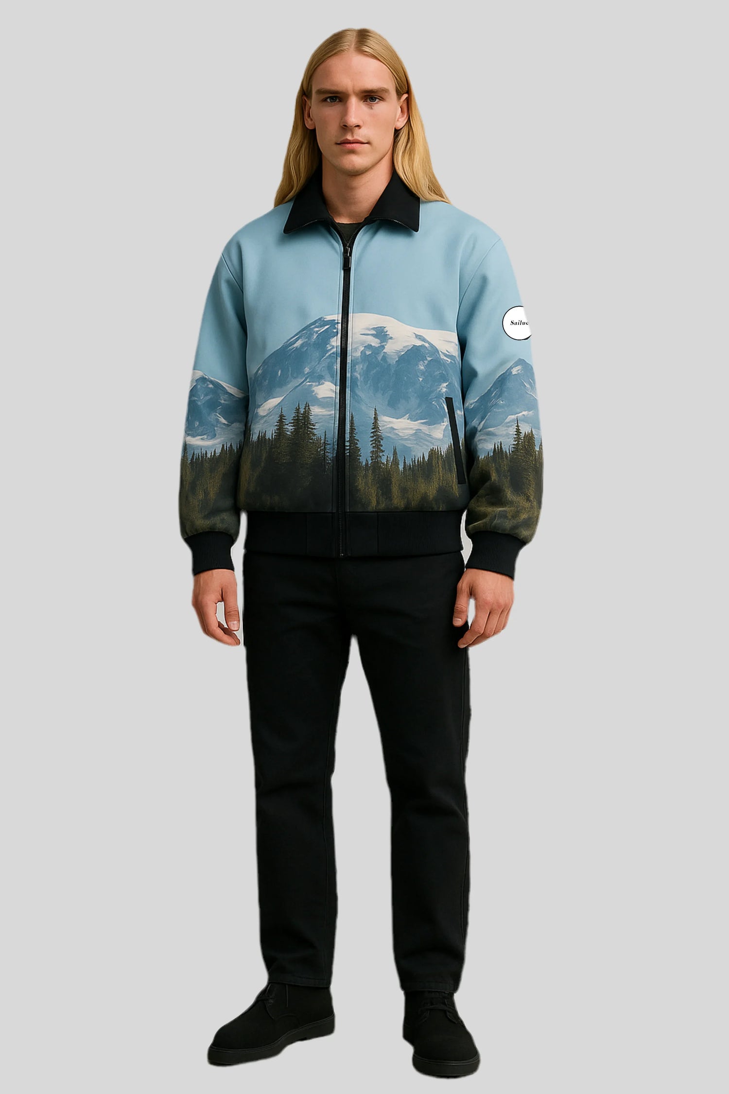 Man in Sailuc luxury mountain print jacket, black pants, black shoes on gray background.
