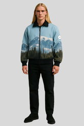 Man in Sailuc luxury mountain print jacket, black pants, black shoes on gray background.