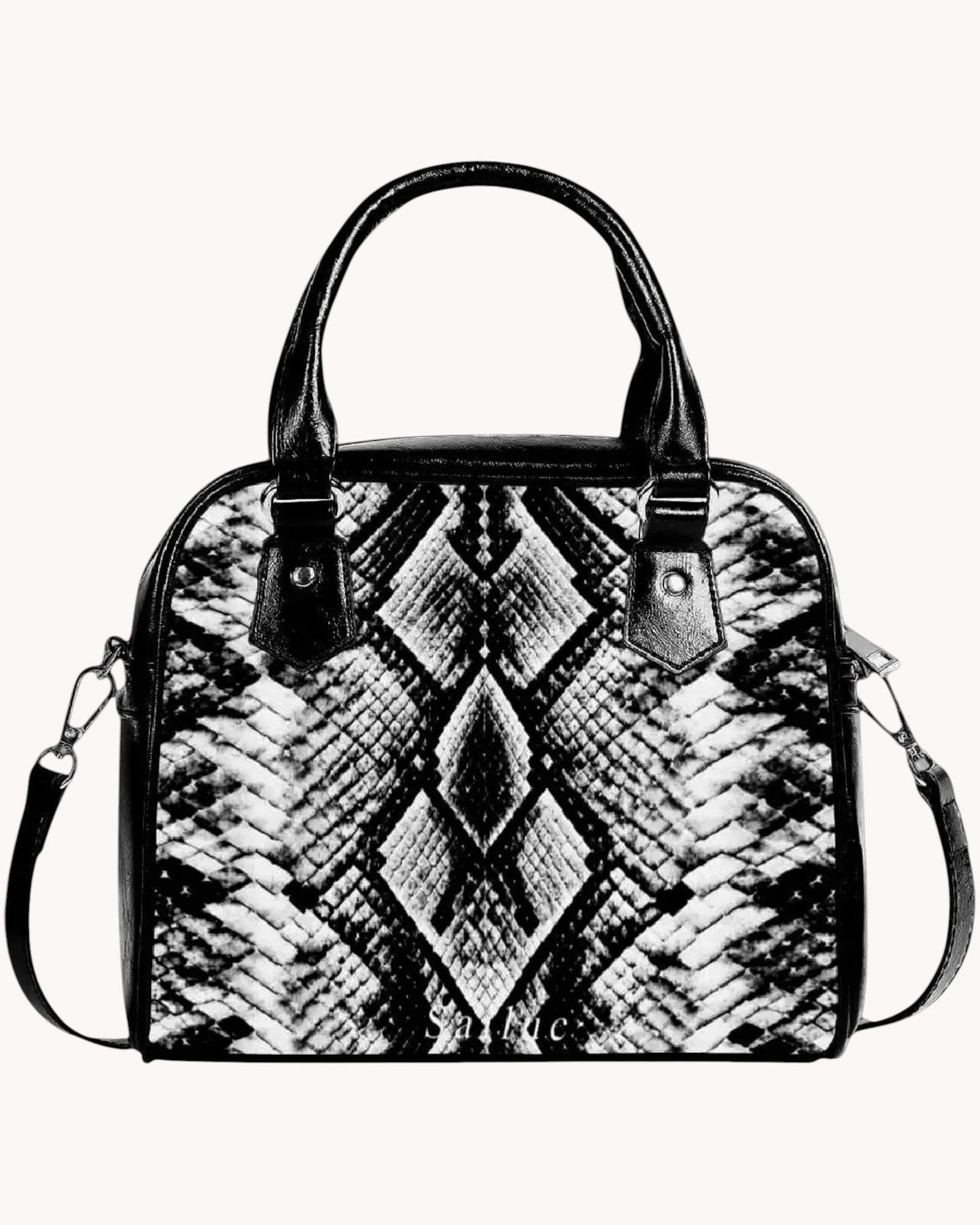 Black and white patterned handbag on a gray background