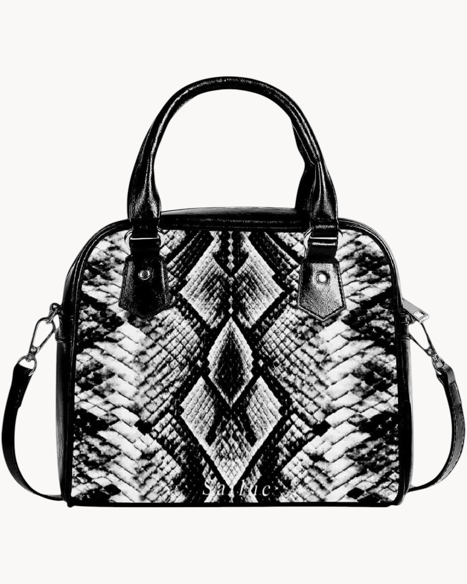 Black and white patterned handbag on a gray background