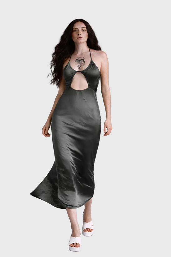 Woman wearing a sky dress with cut-out design on a gray background