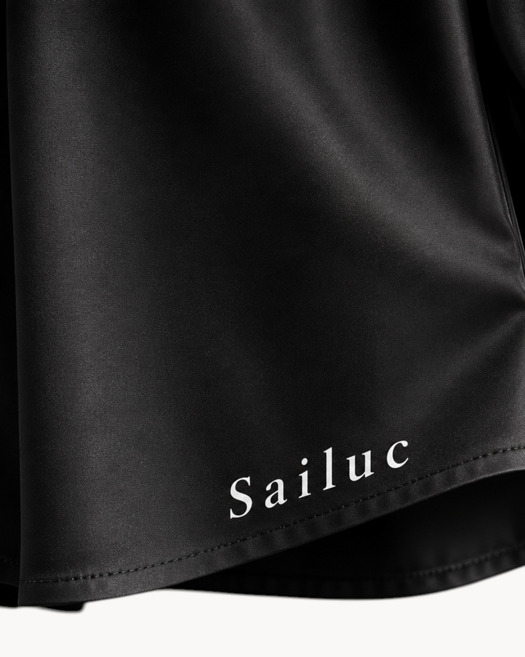Sailuc Linea longline shirt in black with a classic collar, buttoned cuffs, and white stitching detail.