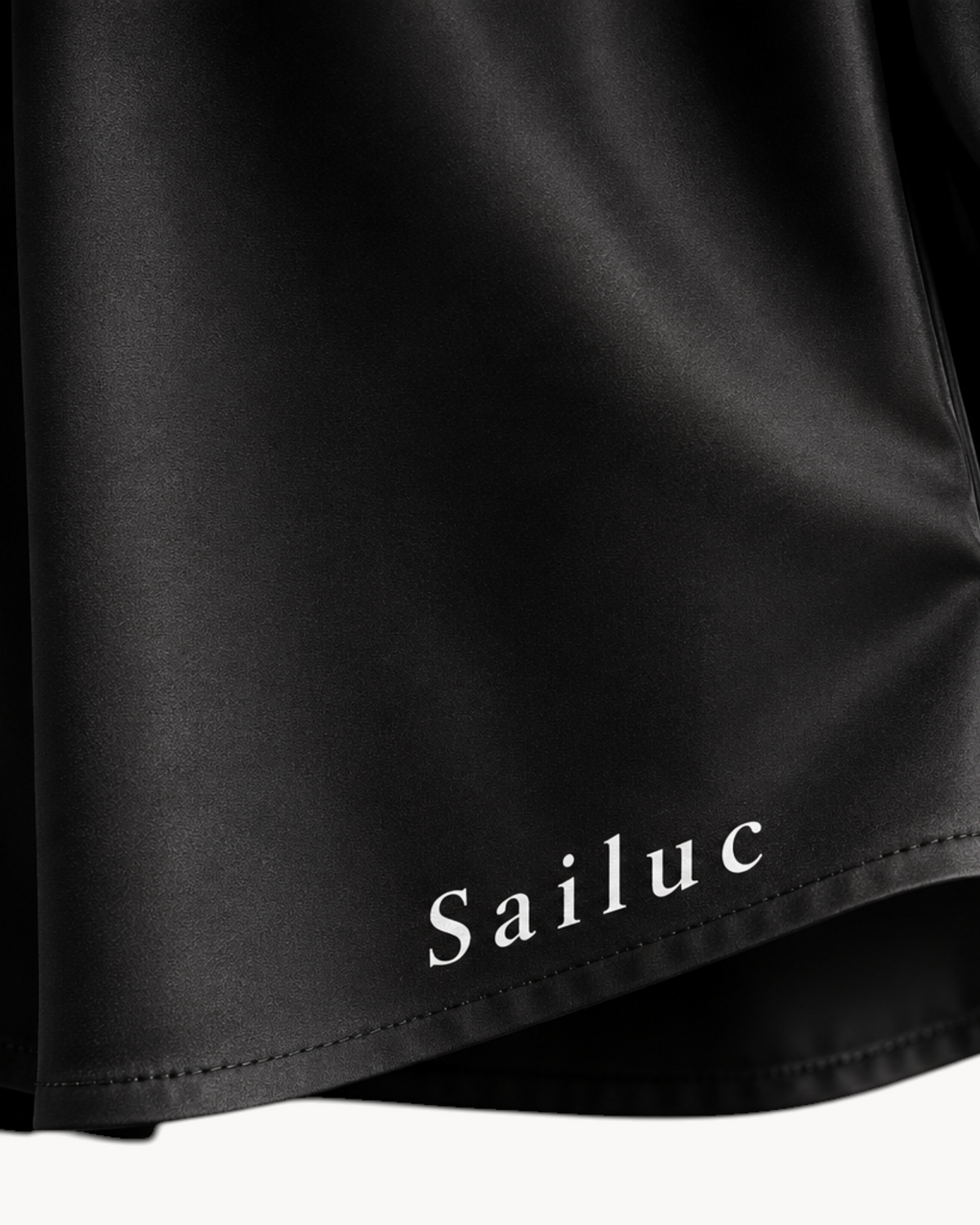 Sailuc Linea longline shirt in black with a classic collar, buttoned cuffs, and white stitching detail.