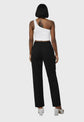 Person wearing a white tank top and black pants on a gray background