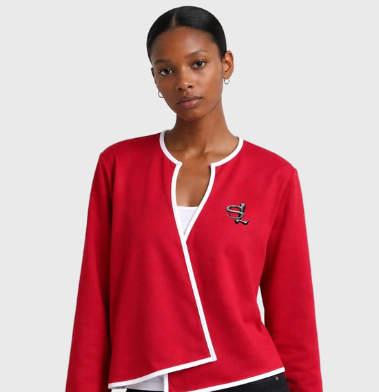 Woman wearing a red outerwear with a white shirt underneath on a white background