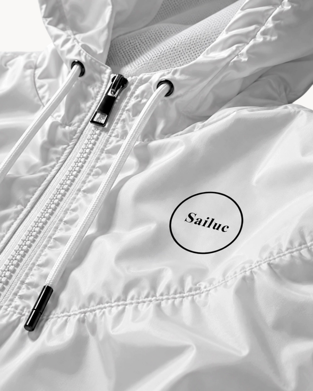 Sailuc white cropped windbreaker featuring a half-zip front, adjustable hood drawcords, and technical fabric.