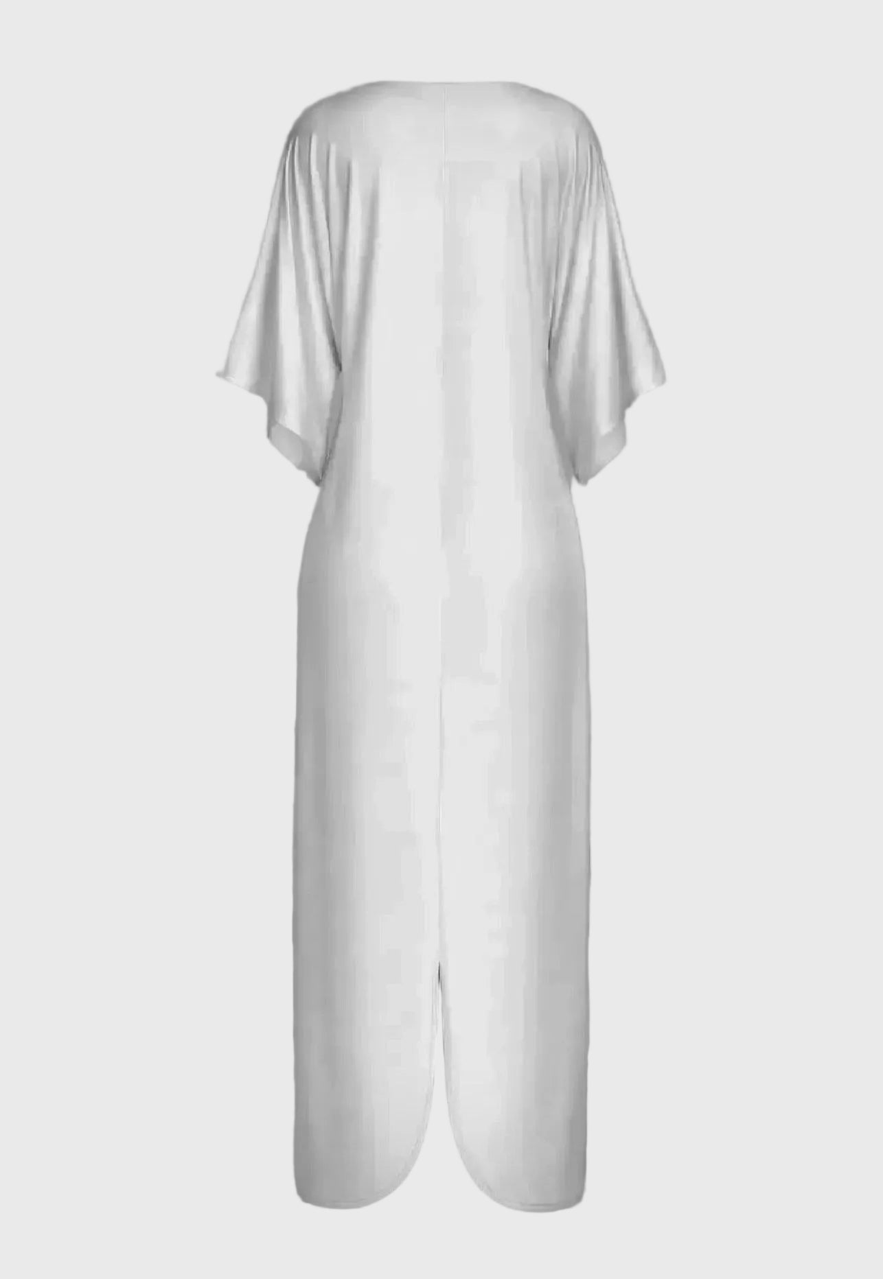 White dress with a draped design on a gray background