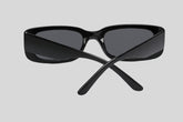 Sailuc luxury black sunglasses with wide arms, shown from the back on a grey background