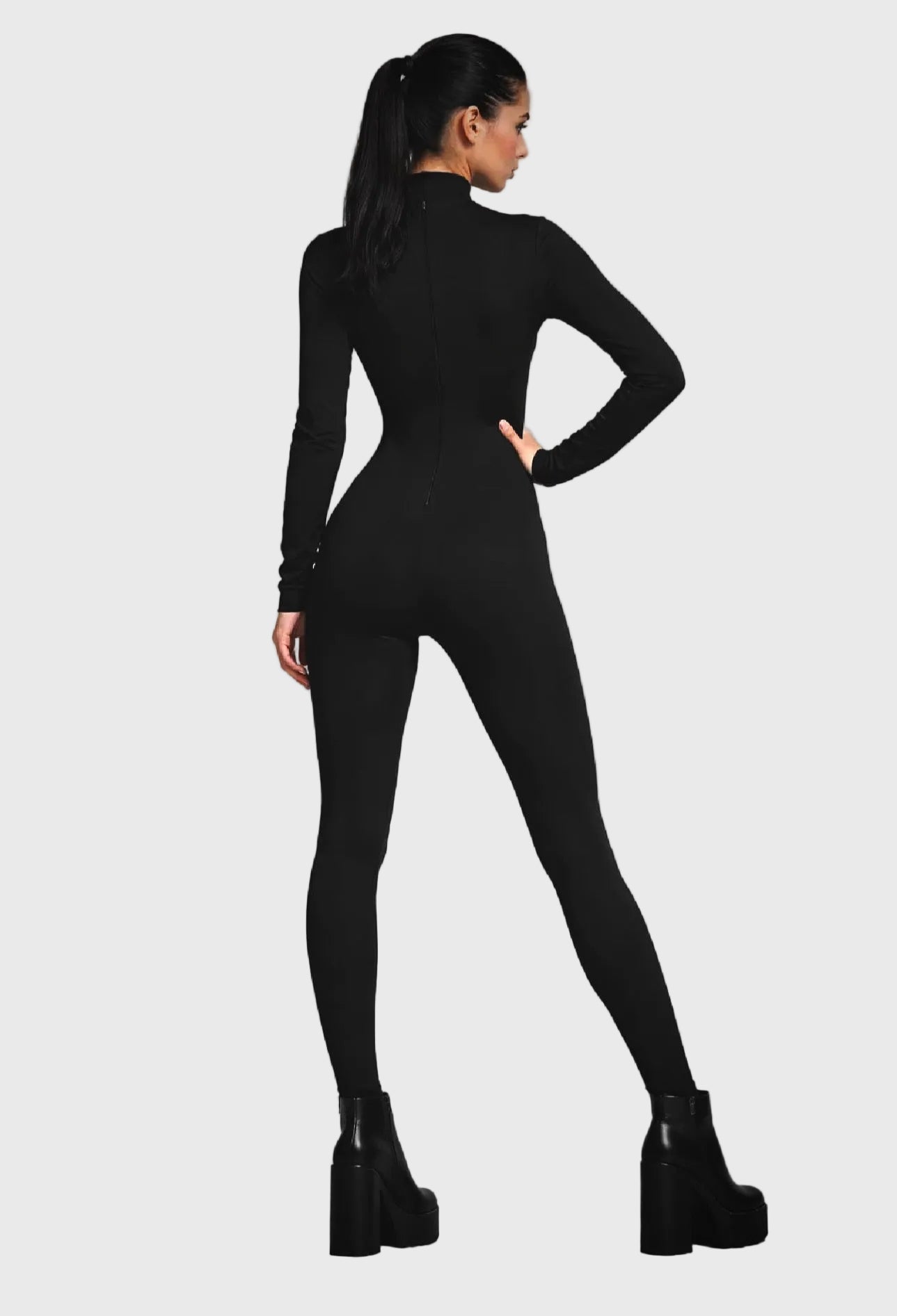 Person wearing a black bodysuit on a gray background