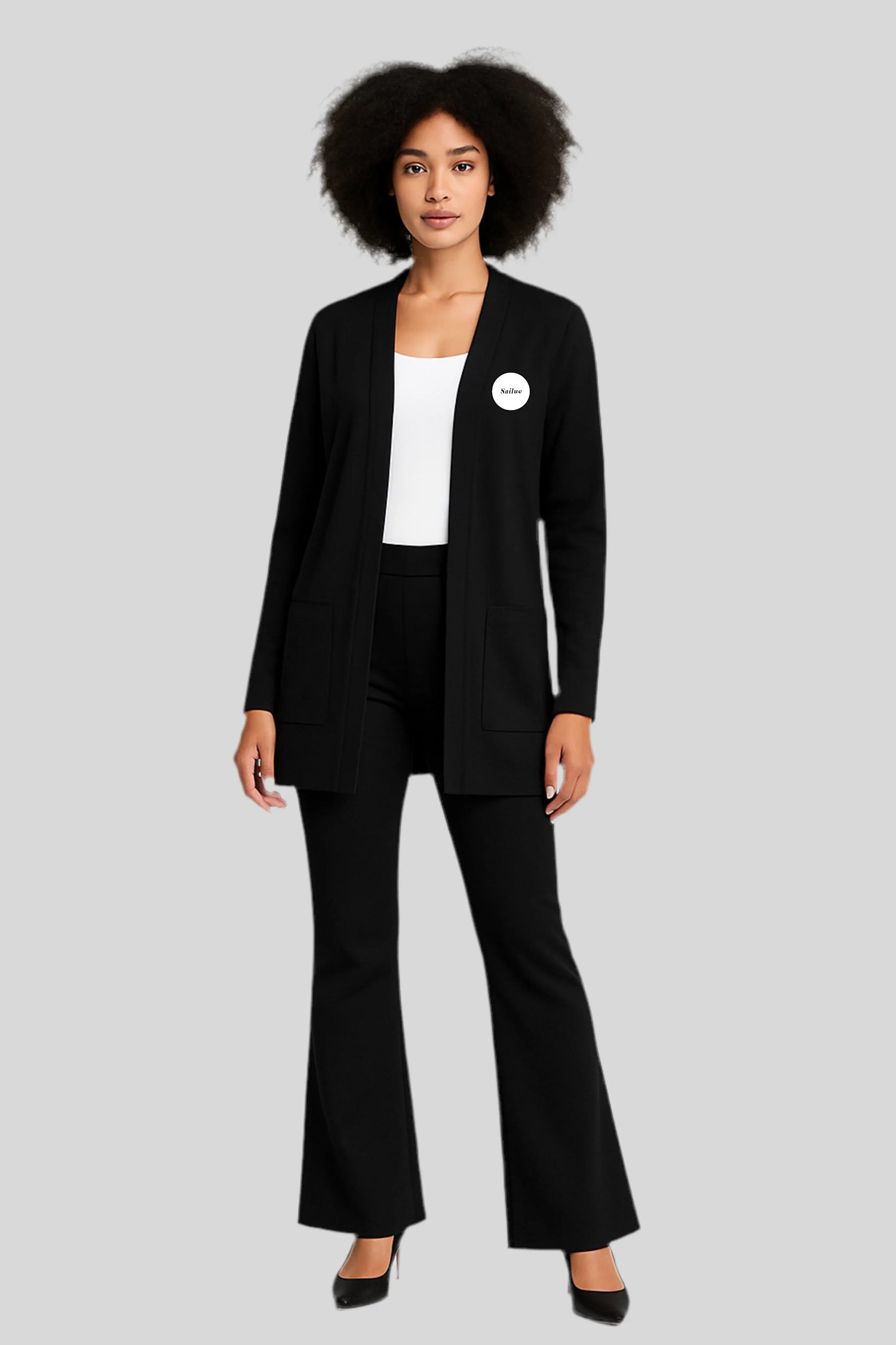 Woman modeling Sailuc black cardigan and pants, modern luxury fashion on gray background