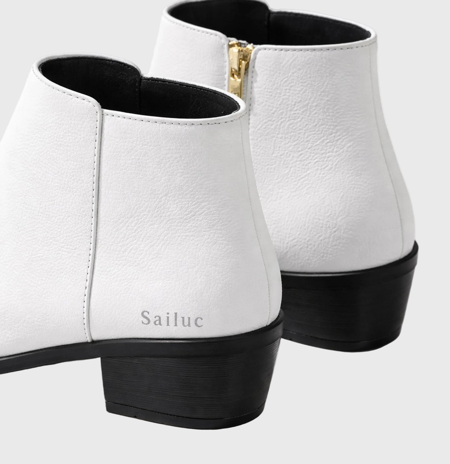 White ankle boots with black soles on a light gray background, featuring the brand Sailuc