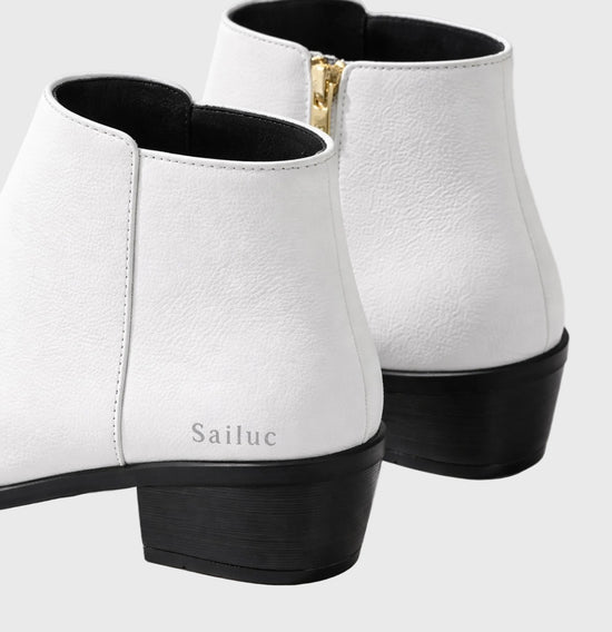 White ankle boots with black soles on a light gray background, featuring the brand Sailuc