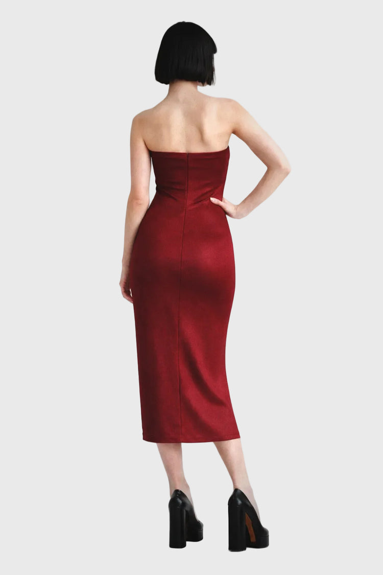 Woman wearing a strapless red dress on a gray background