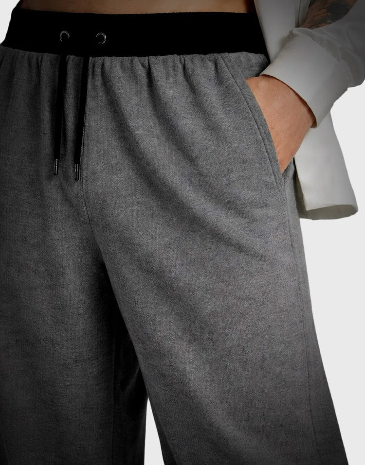 Gray sweatpants with a black waistband on a neutral background