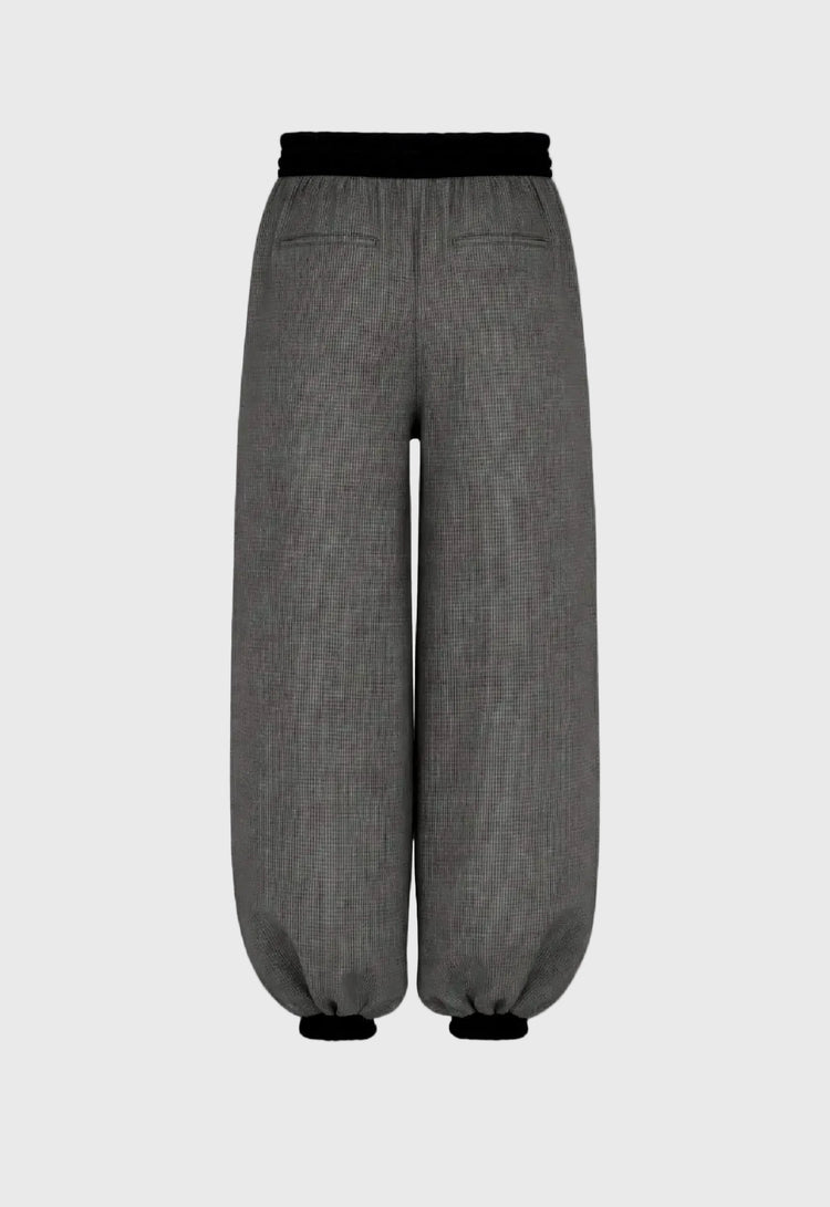 Gray pants with black waistband on a gray background