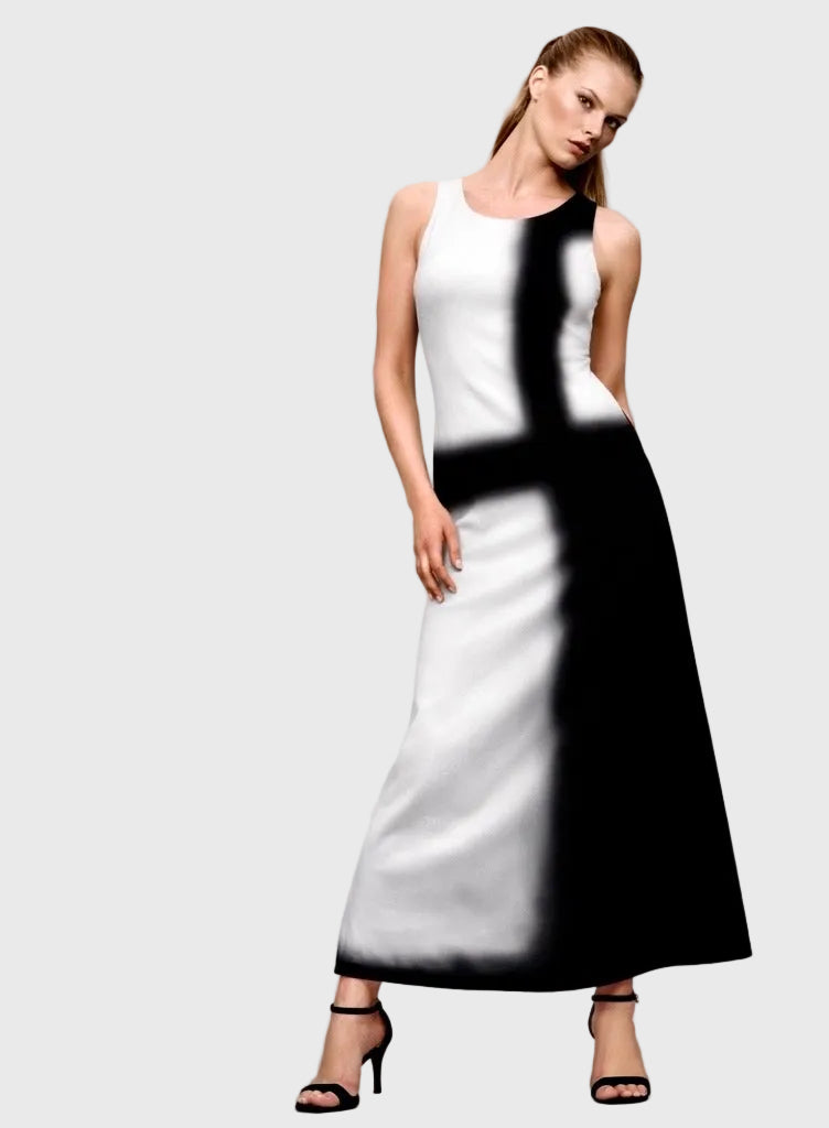 Woman wearing a black and white dress against a gray background