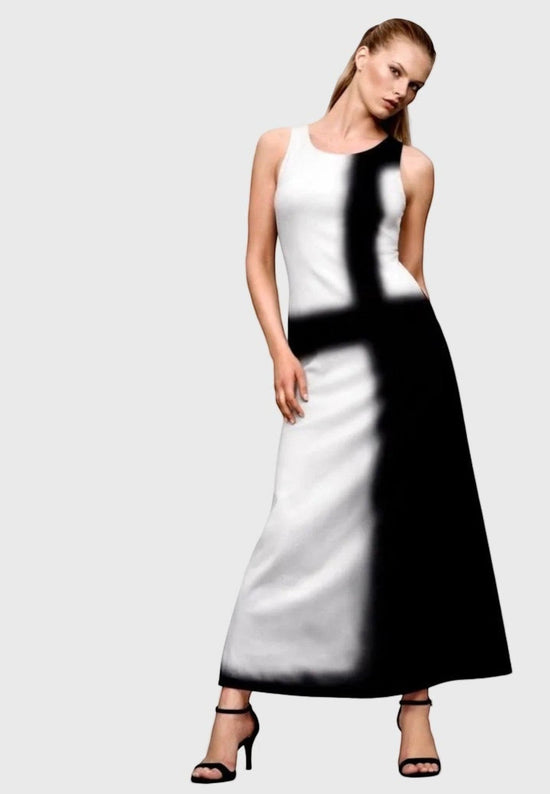 Woman wearing a black and white dress against a gray background